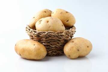 Raw potatoes organic tuber is a vegetarian harvest new on the basket on white background.