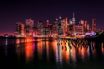 Fototapeta na wymiar Old Brooklyn pylon piers with Lower Manhattan New York. NYC, USA