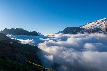 Great view of the foggy marmolada with pass pordoi. National Park. Dolomites (Dolomiti), South Tyrol. Location Canazei, Campitello, Mazzin. Italy, Europe. Dramatic scene. Beauty world.