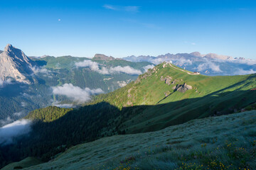Fototapeta premium Panorama of the Piz Boe mountain range at sunny foggy morning. View from Pordoi pass. Dolomites mountains, Italy, Europe.