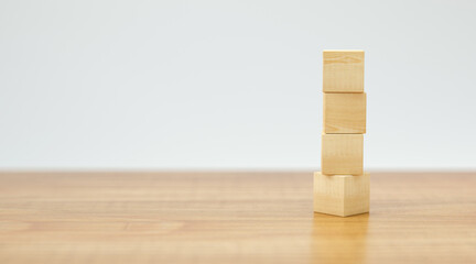empty wooden cubes for own messages and icons on wooden floor and white background