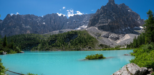 Wonderful hiking, photography and recreation place. Famous lake Sorapis with high snowy mountains at sunset, Dolomites, Italy, Europe