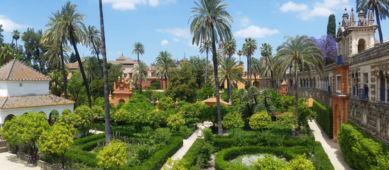 Lush manicured gardens of the Alcazar Moorish castle in Spain - obrazy, fototapety, plakaty