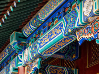 Detail of colorful traditional painting on the roof of Chinese temple