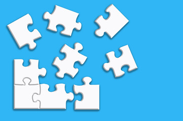 Fototapeta premium White puzzle with shadows on a blue background.