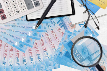 2000 russian rubles bills and calculator with glasses and pen. Tax payment season concept or...