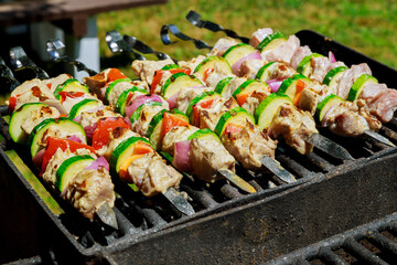 BBQ skewers shish kebab with vegetables on flaming grill.