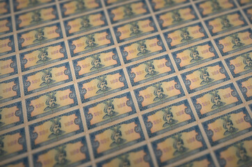 5 Ukrainian hryvnias bills printed in illegal money production conveyor. Collage of many fake...