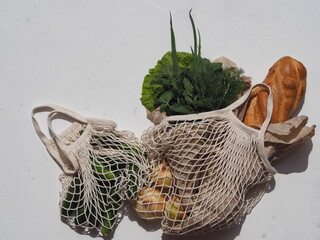 The idea of a lifestyle with a minimum of waste.White eco-friendly reusable knitted mesh with fresh...