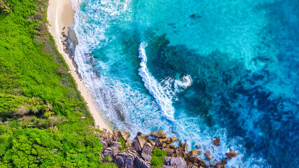 Amazing aerial view of Grand Anse in La Digue Island, Seychelles. Ocean and forest