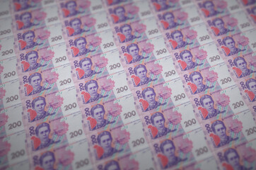 200 Ukrainian hryvnias bills printed in illegal money production conveyor. Collage of many fake...