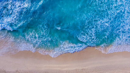 Amazing overhead aerial view of island shoreline with waves along the ocean