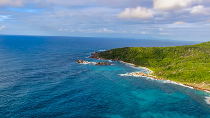 Fototapeta na wymiar Aerial view of tropical island with sea, vegetation and shoreline