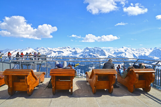 Travelers enjoy sun light at the sun terrace on Stanserhorn mountain