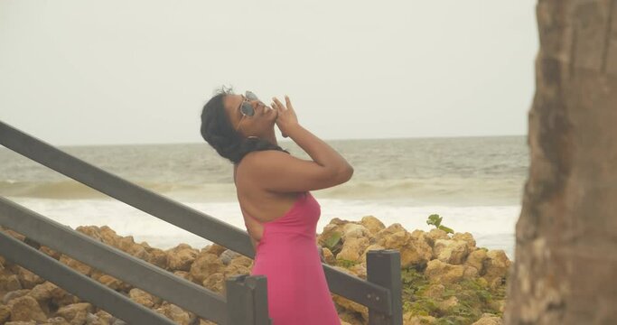 A happy east indian model enjoying the sea breeze at this coastline Caribbean location
