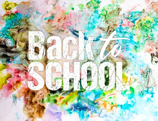 Back to school graphic text written over colorful paint splatter background 