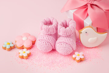 close up of baby shoes, baby shower decoration - sweetness and baby booties on pink background, first newborn party background, birthday, gift present giving concept, celebrate card