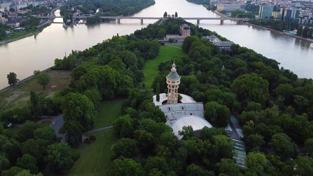 Aerial view of beautiful margaret island with water tower surrounded by forest in Budapest