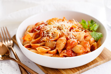 Pasta conchiglie with tomato sauce and parmesan cheese