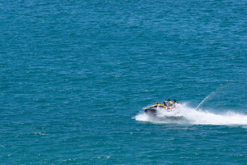 Obraz premium Males Riding Jet-ski at Sea