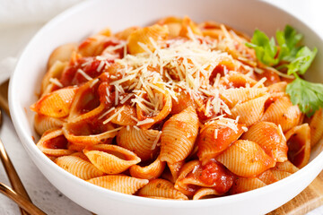 Pasta conchiglie with tomato sauce and parmesan cheese