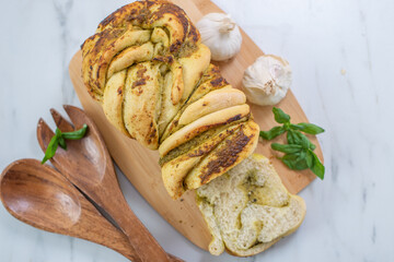 home made braided basil pesto bread on a table