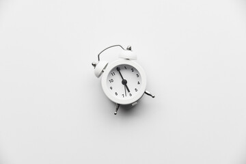 Close up of white vintage retro alarm clock isolated on white background with copy space. Morning,...
