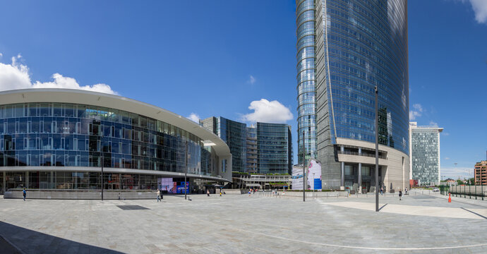 Milano, Italy. Gae Aulenti Square At Unicredit Tower. Partial View Of Modern Square With Its Artificial Lake. Some People Walking At The Square During Covid-19 Or Coronavirus Time