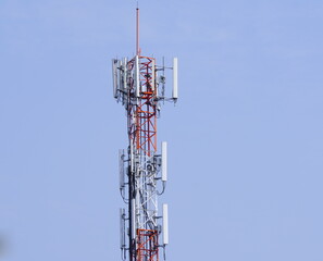 Small Cell 3G, 4G, 5G System. Macro Base Station or Base Transceiver Station. Wireless Communication Antenna Transmitter  tower against blue sky background.
