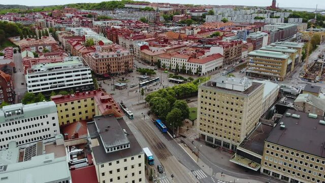 The Beautiful City Of Gothenburg With The Jarntorget Square And Blue Trams Travelling On The Road At Daytime In Sweden.  -aerial drone
