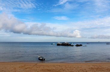 View of Tioman Island with the dramatic cloudscape, boats and rocks in the morning, Tioman Island