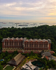 Singapore, July 17,'2020: Aerial drone view of Singapore city skyline at sunset. 
Selective focus. Landscape shot of Singapore.  Singapore docks in the background. Red hotel building.