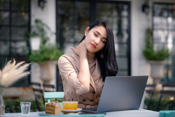 Young woman workingin garden and having neck pain.