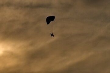 paraglider in the sky at sunset