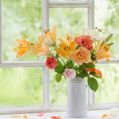 summer flowers in vase on background window with drops water