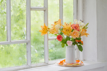 summer flowers in vase on background window with drops water