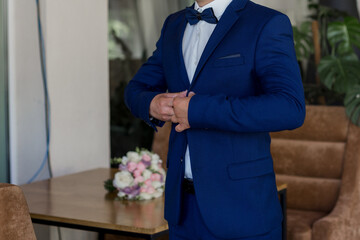 man in blue suit and bow tie