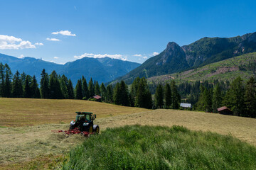 Tractor Turning Hay in the field