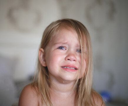 portrait of a beautiful little crying girl