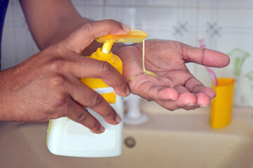 woman washing hands by hand sanitizer 