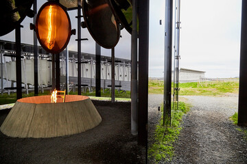 Vardo, Norway - 23 June 2019: Stylized bonfire and mirrors in a black cubic building with glass in the Museum a memorial dedicated to burned at the stake and dead witches in time of witch hunt.