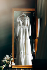 Wedding dress in the room with reflection in mirror