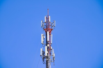 Telecommunication tower of 4G and 5G cellular. Macro Base Station. Wireless Communication Antenna Transmitter. Telecommunication tower with antennas against blue sky background.