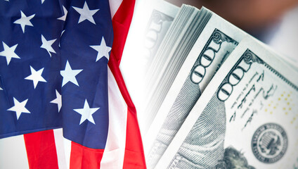 USA American flag and 100 dollars banknotes as background, concept picture about economy