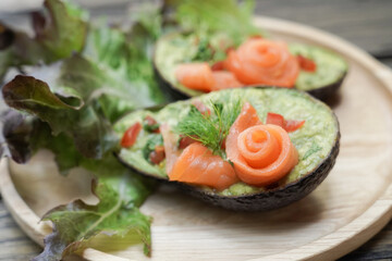 Avocado boats stuffed with smoked salmon rose salad, healthy low carb ketogenic food