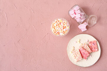 Plate with crispy rice bars and marshmallow on color background