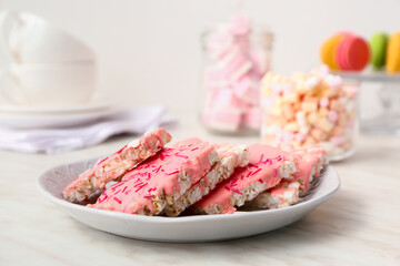 Plate with crispy rice bars on table