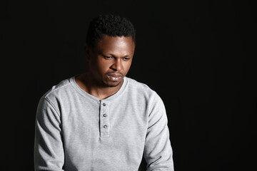 Sad African-American man on dark background. Stop racism