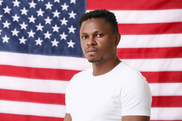 Sad African-American man near national flag of USA. Stop racism