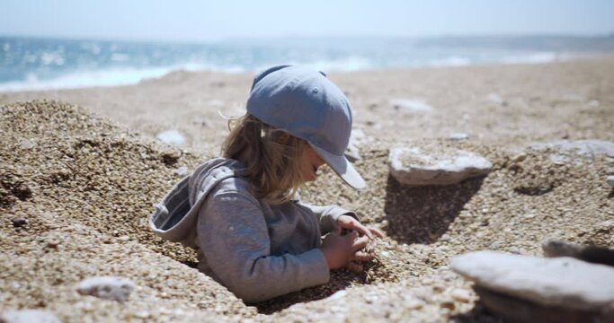 Preschooler boy playing on the beach